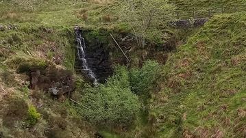 A photo of step 7 of the Three Shires Head Walk route, with red arrows superimposed to show the way.