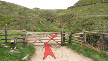 A photo of step 8 of the Three Shires Head Walk route, with red arrows superimposed to show the way.