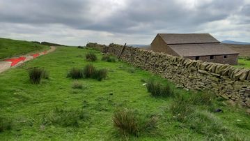 A photo of step 10 of the Three Shires Head Walk route, with red arrows superimposed to show the way.