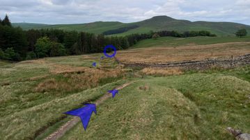 A photo of step 29 of the Three Shires Head Walk route, with blue arrows superimposed to show the way.