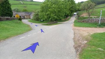 A photo of step 34 of the Three Shires Head Walk route, with blue arrows superimposed to show the way.