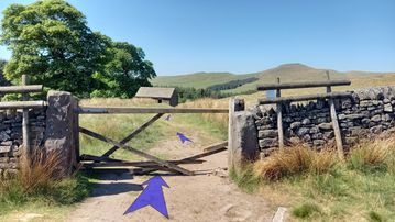 A photo of step 28 of the Three Shires Head Walk route, with blue arrows superimposed to show the way.