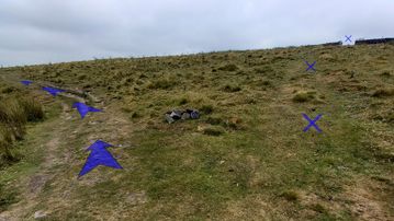 A photo of step 24 of the Three Shires Head Walk route, with blue arrows superimposed to show the way.
