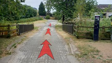 A photo of step 1 of the Three Shires Head Walk route, with red arrows superimposed to show the way.