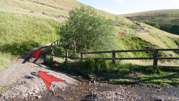 A photo of step 9 of the Three Shires Head route, with red arrows superimposed to show the way.