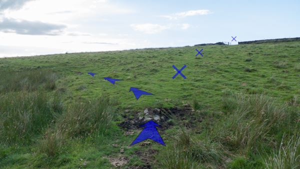 A photo of step 2 of the Three Shires Head route, with blue arrows superimposed to show the way.