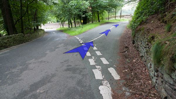 A photo of step 10 of the Three Shires Head route, with blue arrows superimposed to show the way.