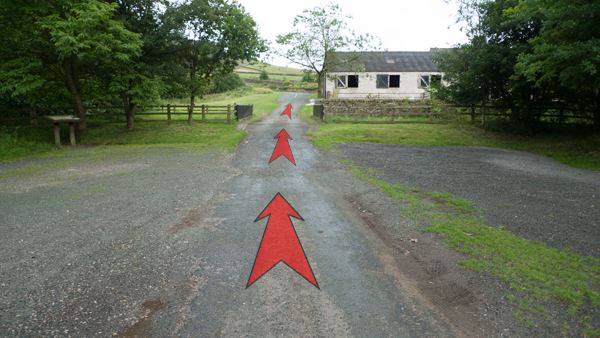 A photo of step 1 of the Three Shires Head route, with red arrows superimposed to show the way.