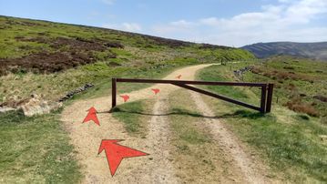 A photo of step 2 of the Wildmoorstone Valley Walk route, with red arrows superimposed to show the way.