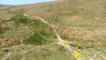 A photo of step 8 of the Wildmoorstone Valley Walk route, with yellow arrows superimposed to show the way.