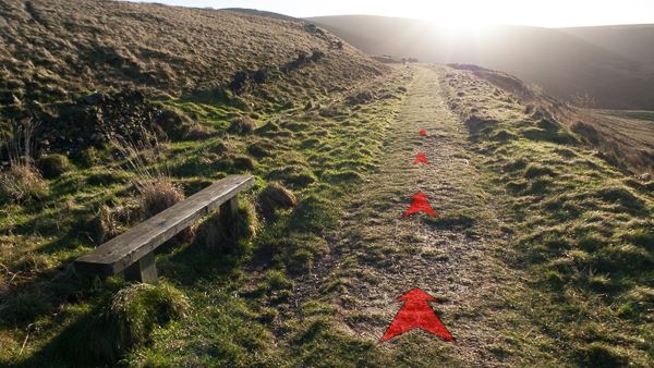 A photo of step 5 of the Wildmoorstone Valley route, with red arrows superimposed to show the way.