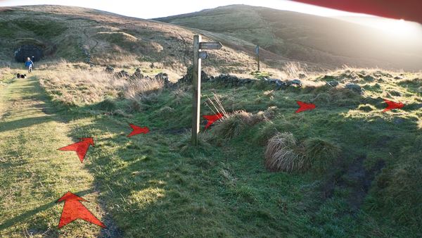 A photo of step 6 of the Wildmoorstone Valley route, with red arrows superimposed to show the way.